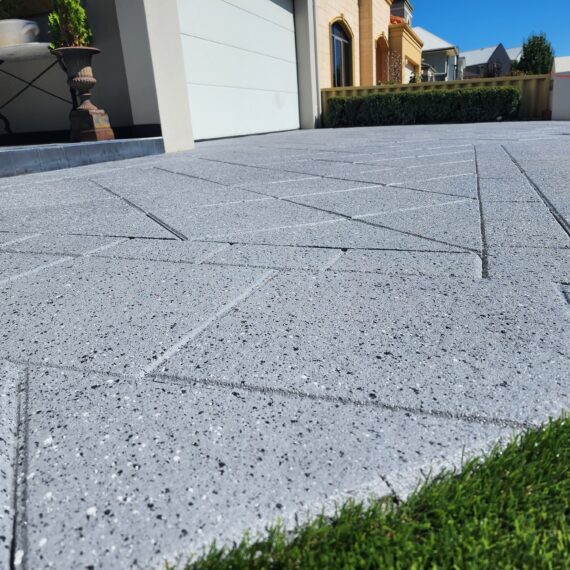 Concrete resurfacing specialists working on a Perth driveway