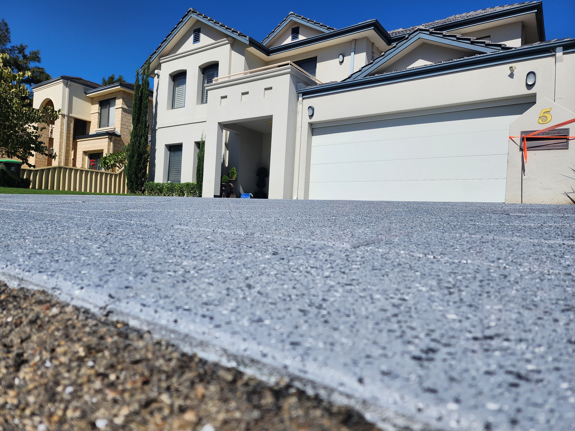 Concrete resurfacing specialists working on a Perth driveway